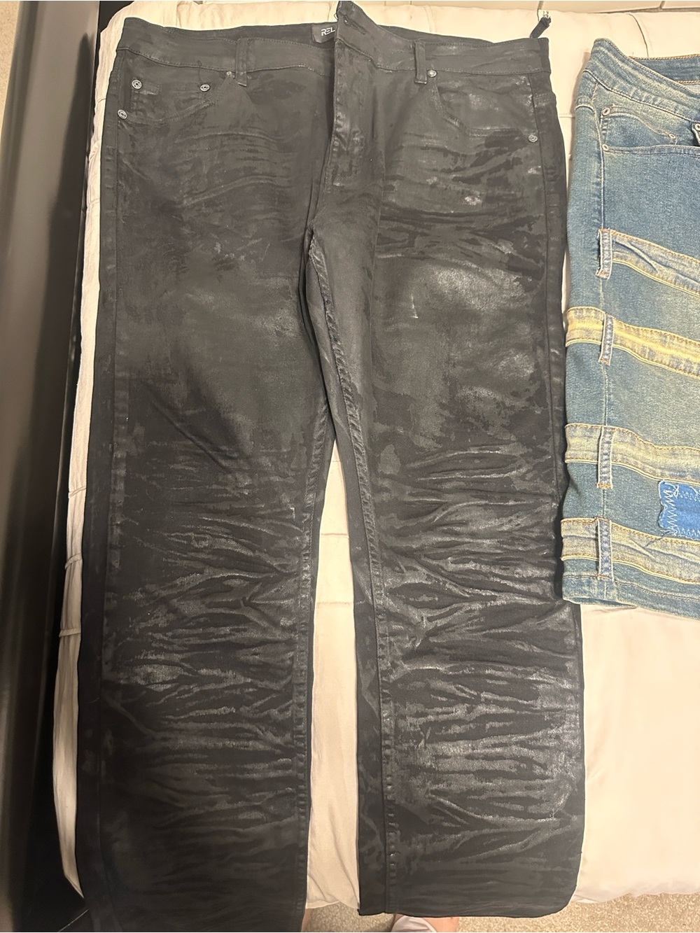 Men’s black shiny jeans.